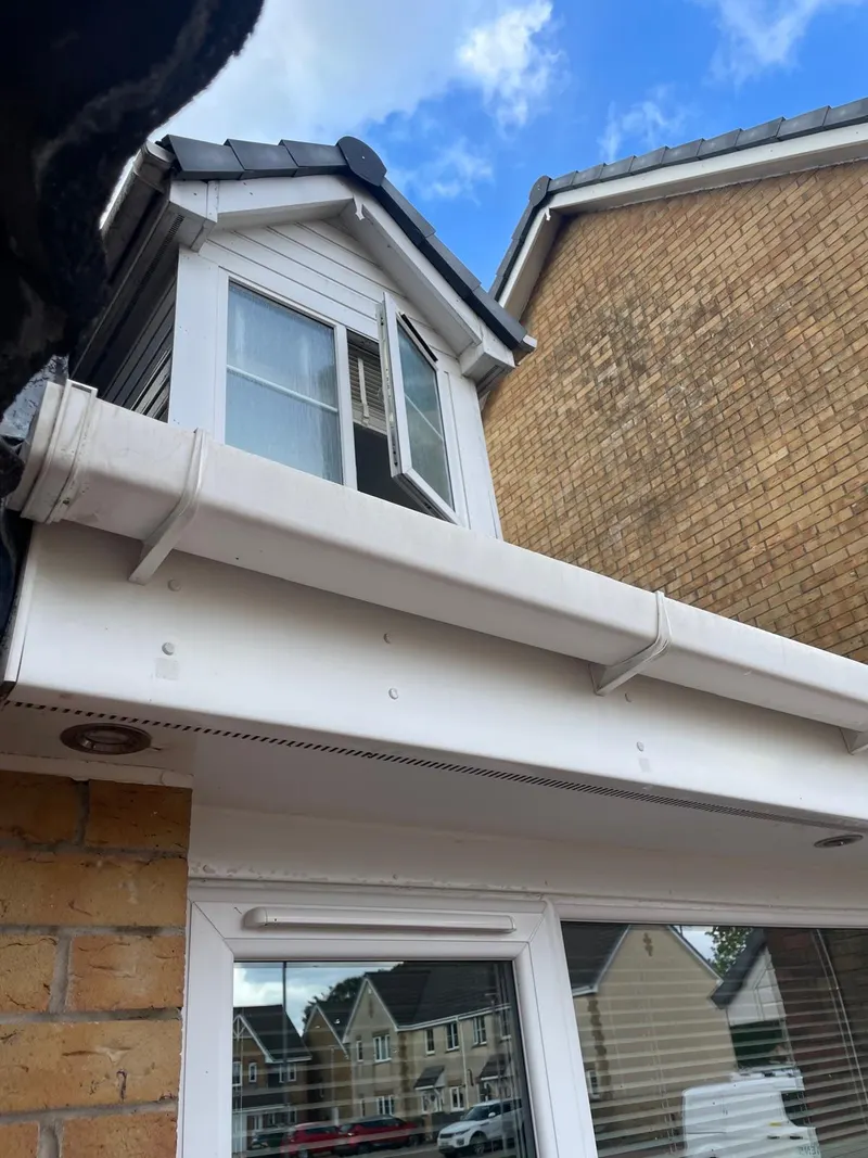 The same white gutter exterior, fascia and soffit after cleaning